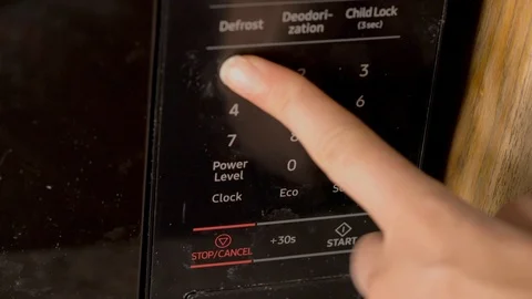 Fingers use dirty microwave timer Stock Footage 111620695
