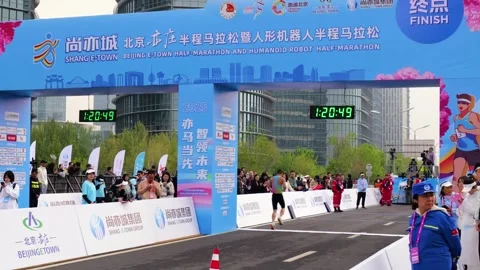 Finish line of the Beijing E-Town Half-Marathon and Humanoid Robot Stock Footage 309294052