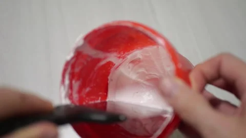 Finish Plaster Being Mixed in Red Bucket with Metal Spatula Creating Thick Stock Footage 321528289