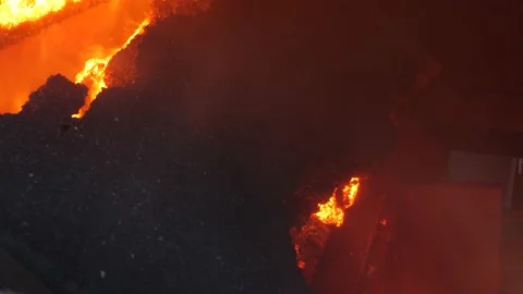 The finished agglomerate falls onto the crushers. Stock Footage 139693140