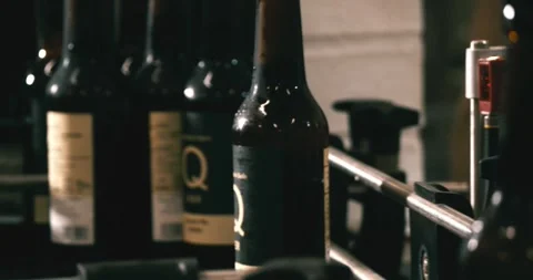 Finished beer bottles at end of conveyor belt in Berlin brewery July 2020 Video stock 335141893