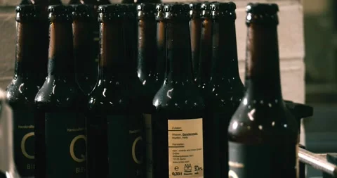 Finished beer bottles at end of conveyor belt in Berlin brewery July 2020 Stock Footage 335142437