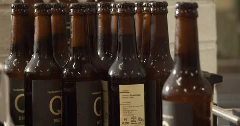 Finished beer bottles at end of conveyor belt in Berlin brewery July 2020 Stock Footage 335142495