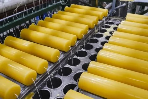 Finished candles pulled out of mold into which they were poured and hardened Stock Photos