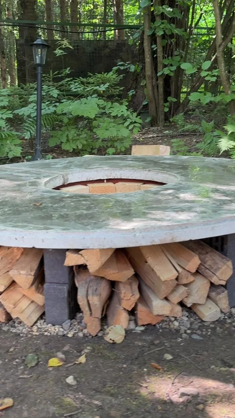Finished DIY Round Concrete Fire Pit Table with Firewood Storage Stock Footage 342002104