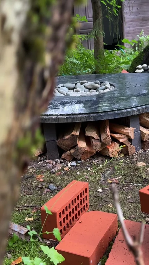 Finished DIY Round Concrete Fire Pit Table with Firewood Storage Stock Footage 342002154