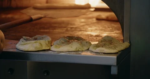 Finished Flatbreads on edge of Fire Oven Stock Footage 129849199