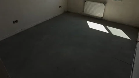 Finished floor screed with installed radiator in unfinished apartment Vídeo Stock 343449614