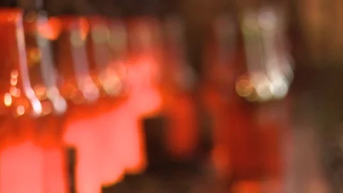 Finished glass beer bottles incandescent in production line slow motion Stock Footage