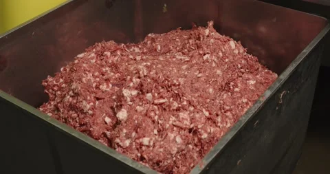 The finished minced meat is placed in a large iron container to make a sausage Stock Footage 232213579