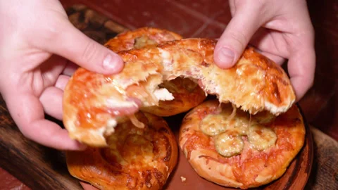 The finished mini pizza is torn in half Stock Footage 249882082