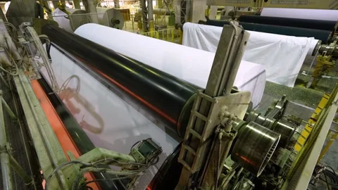 The finished paper in the roll comes out of the paper machine. Paper production Video stock 301465910