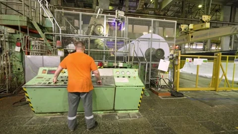 The finished paper in a roll comes out of the paper machine Stockbeeldmateriaal 301973512