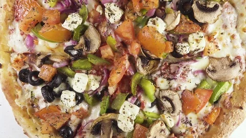 Finished pizza in a cardboard box rotates in a circle top view Stock Footage 101017070