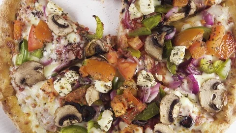 Finished pizza in a cardboard box rotates in a circle top view Stock Footage 101017180