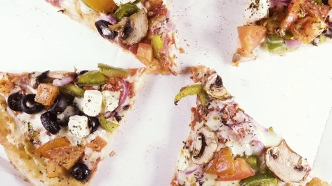 Finished pizza in a cardboard box rotates in a circle top view Video stock 101017292