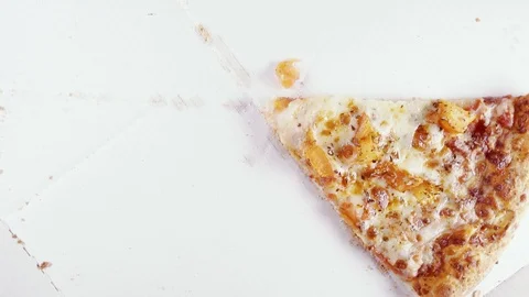 Finished pizza in a cardboard box rotates in a circle top view Stock Footage 101017904