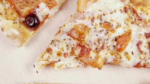 Finished pizza in a cardboard box rotates in a circle top view Video stock 101018965