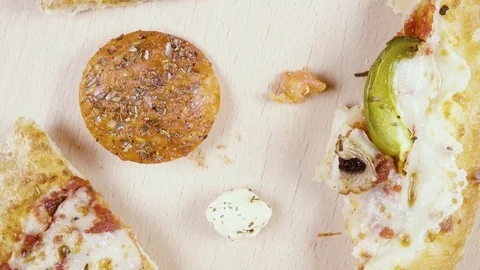 Finished pizza in a cardboard box rotates in a circle top view Stock Footage 101019229