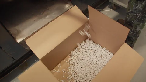 Finished plastic components are discharged into box after molding cycle Stock Footage 314197101