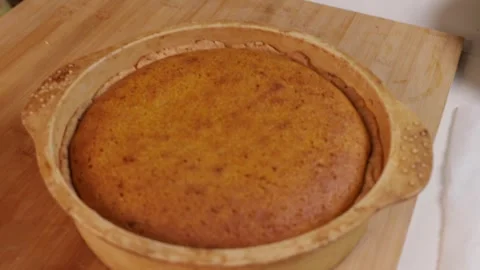 The finished pumpkin pie is removed from the oven and placed on the table Stock Footage 286116876