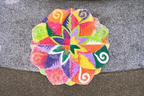 The finished rangoli decorated by multi-colored rice on the floor Stock Photos