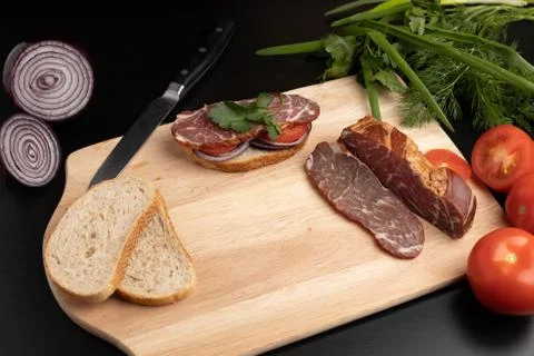 The finished sandwich on the kitchen Board with different ingredients Stock Photos