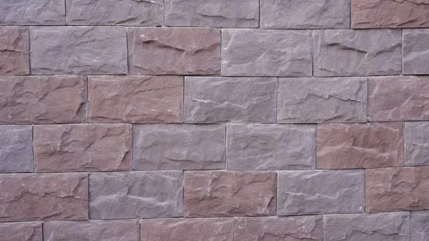 Finished section of a facade with decorative stone tiles installed on the wall. Stock Footage 318470946