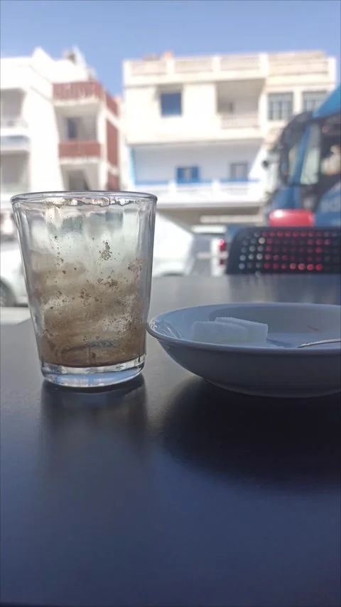 Finished Traditional Moroccan Mint Tea Glass on Outdoor Cafe Table Stock-Footage 341671049