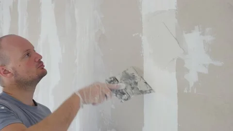 Finishing and Patching Drywall Walls by Caucasian Remodeler. Construction Stock Footage 147515514
