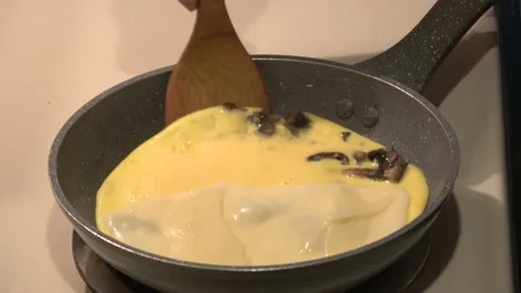 Finishing a cheese omlette cooking process. Stock Footage 207524118