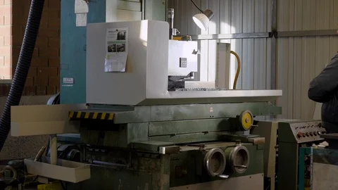 Finishing metal working on horizontal surface grinder machine with flying sparks Stock Footage 99134600