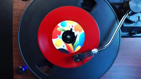 Finishing Playback of Red Single Vinyl Record on Turntable, Top Down View Stock Footage 325708107