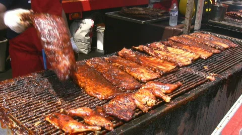 Finishing Pork Ribs On A Commercial Charcoal Barbecue BBQ Stock Footage