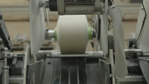 Finishing a spool of white wire on a machine in a factory Stock Footage 291870678