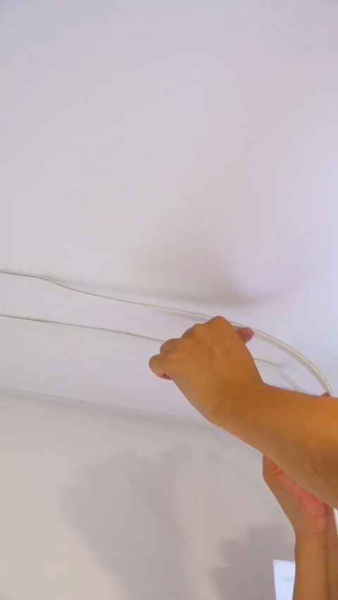 Finishing Stretch Ceiling Edge with Flexible White Insert Stock Footage 345981670