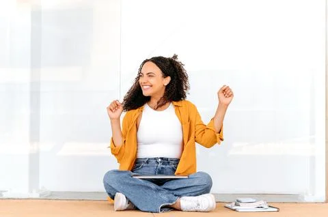 Finishing work or study. Joyful curly haired latino or brazilian female student Stock Photos