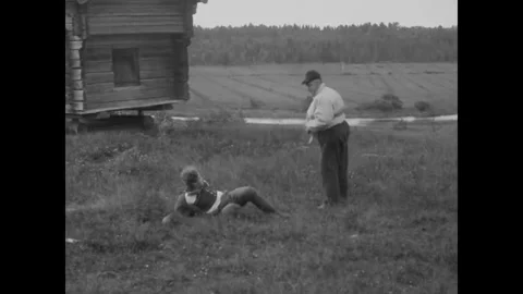 FINLAND - 1923 - in this silent comedy, a peasant whips a young man with his Stock Footage 337958840