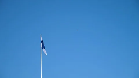 Finland, Finnish flag, in the wind with blue summer sky. Stock Footage