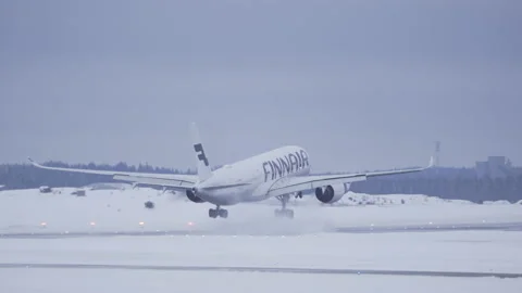 Finnair Airbus A350 Passenger Airplane Landing in Helsinki Airport, Snow, Winter Stock Footage