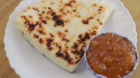 Finnish cheese with cloudberry jam in a white plate on wood Stock-Footage 60405699