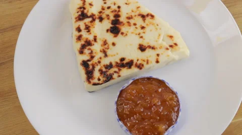 Finnish cheese with cloudberry jam on a white plate Stock-Footage 60405786