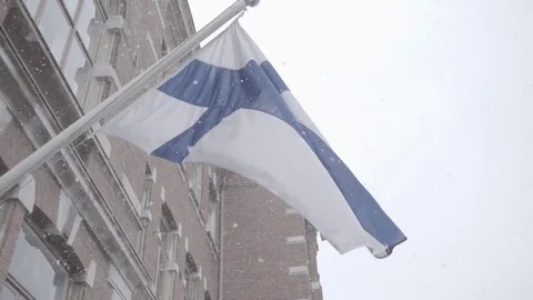 Finnish flag waving while snowing 250fps Stock Footage 75469177