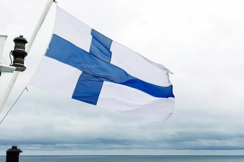 Finnish flag waving in the wind on Baltic Sea on a passenger ferry travelli.. Stock Photos