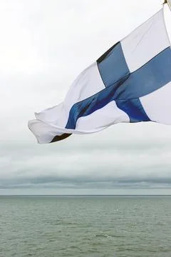 Finnish flag waving in the wind on Baltic Sea on a passenger ferry travelli.. Stock Photos
