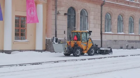 Finnish small tractor Wille 355 is plowing snow during snowstorm day Stock Footage 187128400