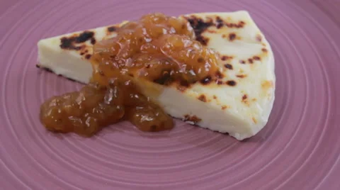 Finnish squeaky cheese with cloudberry jam on a purple plate Video stock 60406591