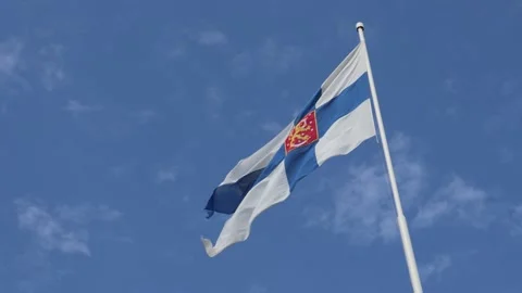 Finnish State Flag Waving Against Blue Sky in Helsinki, Finland Stock Footage 313499707