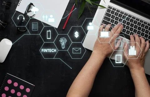 "Fintech" word on digital virtual screen with laptop, male hands, notebook,ey Stock Photos