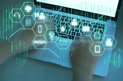 "Fintech" word on digital virtual screen with male hands typing laptop backgr Stock Photos